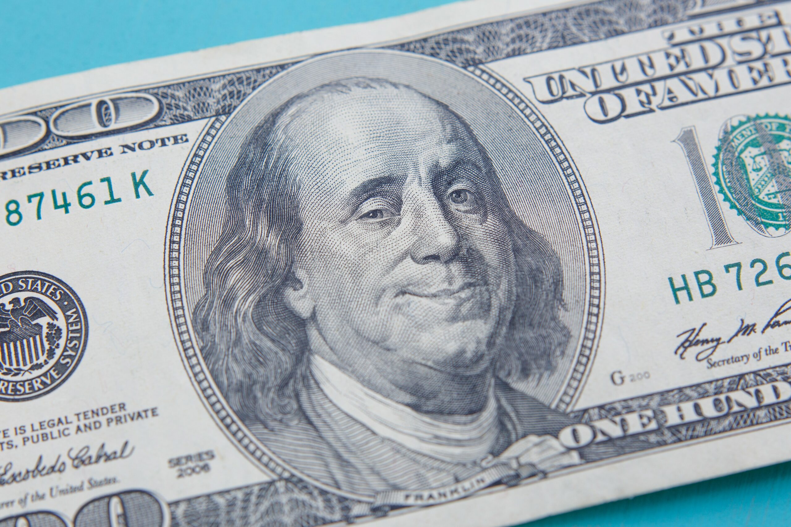 US hundred dollar bill with smiling and winking Benjamin Frankli